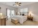 Main bedroom with ceiling fan and access to private balcony at 201 S Cooper St, New Smyrna Beach, FL 32169