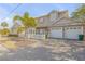 Two-story house with white shutters, a white picket fence, and a three-car garage at 201 S Cooper St, New Smyrna Beach, FL 32169