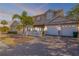 Charming two-story home featuring a three-car garage, white picket fence, and lush landscaping at 201 S Cooper St, New Smyrna Beach, FL 32169