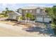 Two-story house with metal roof, white shutters, and a white picket fence at 201 S Cooper St, New Smyrna Beach, FL 32169