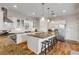 Kitchen with large island, white cabinets, and stainless steel appliances at 201 S Cooper St, New Smyrna Beach, FL 32169