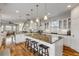 Kitchen with large island, white cabinets, and stainless steel appliances at 201 S Cooper St, New Smyrna Beach, FL 32169