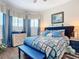 Well-lit bedroom with blue accents, including curtains, bedding, and decorative furniture at 205 Blue Starfish Pl, Daytona Beach, FL 32124