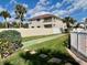 Backyard with bocce ball court, lush landscaping, and partial view of the community pool at 2100 N Peninsula Ave # 216, New Smyrna Beach, FL 32169