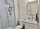 Modern bathroom with a walk-in shower and white vanity at 2100 N Peninsula Ave # 216, New Smyrna Beach, FL 32169