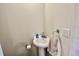 Simple half-bathroom with pedestal sink and towel rack at 2100 N Peninsula Ave # 216, New Smyrna Beach, FL 32169