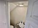 Clean, compact half-bathroom with a pedestal sink and toilet at 2100 N Peninsula Ave # 216, New Smyrna Beach, FL 32169