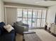 Living room with sliding doors leading to a balcony overlooking the water at 2100 N Peninsula Ave # 216, New Smyrna Beach, FL 32169