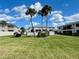 Community pool area with lush landscaping and palm trees at 2100 N Peninsula Ave # 216, New Smyrna Beach, FL 32169