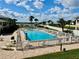 Community pool with patio furniture and waterfront view at 2100 N Peninsula Ave # 216, New Smyrna Beach, FL 32169