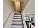 Modern staircase with wood steps and white railings at 2100 N Peninsula Ave # 216, New Smyrna Beach, FL 32169