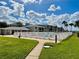 Community pool with a gate and grassy area at 2100 N Peninsula Ave # 216, New Smyrna Beach, FL 32169