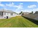 Large grassy backyard with privacy fence at 2302 S Atlantic Ave, New Smyrna Beach, FL 32169