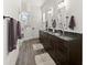 Double vanity bathroom with dark brown cabinets and granite countertops at 2302 S Atlantic Ave, New Smyrna Beach, FL 32169