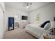 Well-lit bedroom with a queen bed, built-in shelving, and ensuite bath access at 2302 S Atlantic Ave, New Smyrna Beach, FL 32169