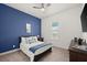 Bright bedroom with a queen-size bed, blue accent wall, and ample natural light at 2302 S Atlantic Ave, New Smyrna Beach, FL 32169