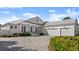 White farmhouse exterior with three-car garage at 2302 S Atlantic Ave, New Smyrna Beach, FL 32169