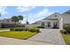 White two-story house with gray roof, three-car garage, and paved driveway at 2302 S Atlantic Ave, New Smyrna Beach, FL 32169