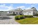 White two-story house with gray roof, three-car garage, and paved driveway at 2302 S Atlantic Ave, New Smyrna Beach, FL 32169