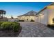 Modern farmhouse exterior featuring a two-car garage and paved driveway at 2302 S Atlantic Ave, New Smyrna Beach, FL 32169