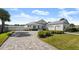 White two-story house with gray roof, three-car garage, and paved driveway at 2302 S Atlantic Ave, New Smyrna Beach, FL 32169