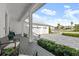 Front porch with seating area, two-car garage, and paved driveway at 2302 S Atlantic Ave, New Smyrna Beach, FL 32169