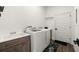 Bright laundry room, washer, dryer, and built-in cabinets at 2302 S Atlantic Ave, New Smyrna Beach, FL 32169