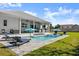 Relaxing pool area with lounge chairs and outdoor dining space at 2302 S Atlantic Ave, New Smyrna Beach, FL 32169