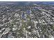 Aerial view of a residential area with houses, trees, and a lake at 2309 Lime Tree Dr, Edgewater, FL 32141