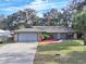 Single-story home with attached garage and well-manicured lawn at 2309 Lime Tree Dr, Edgewater, FL 32141