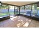 Screened porch overlooks backyard with access to grassy area at 2309 Lime Tree Dr, Edgewater, FL 32141