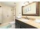 Clean bathroom featuring a shower, toilet and granite vanity at 2325 Willow Oak Dr, Edgewater, FL 32141