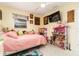 bedroom with a bed, dresser and plenty of toys at 2325 Willow Oak Dr, Edgewater, FL 32141