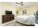 Bright bedroom with a large bed, dresser, and ceiling fan at 2325 Willow Oak Dr, Edgewater, FL 32141