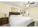 Spacious main bedroom with a king-size bed, nightstand, and ceiling fan at 2325 Willow Oak Dr, Edgewater, FL 32141