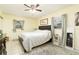 Main bedroom with king-size bed, ceiling fan, and ample floor space at 2325 Willow Oak Dr, Edgewater, FL 32141