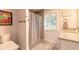 Clean bathroom with shower/tub combo, granite countertop, and a window at 2717 Needle Palm Dr, Edgewater, FL 32141