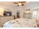 Bright bedroom featuring a dresser, TV, and access to bathroom at 2717 Needle Palm Dr, Edgewater, FL 32141