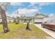 Charming house with green exterior, open garage, and neatly kept front yard at 2717 Needle Palm Dr, Edgewater, FL 32141