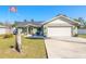 House exterior with a large driveway and American flag at 2717 Needle Palm Dr, Edgewater, FL 32141