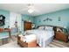 Bright bedroom with teal walls, king bed, and wood furniture at 2720 Queen Palm Dr, Edgewater, FL 32141