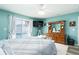 Spacious bedroom with teal walls, king bed, and pool view at 2720 Queen Palm Dr, Edgewater, FL 32141