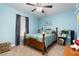 Light blue bedroom with a queen bed and wood furniture at 2720 Queen Palm Dr, Edgewater, FL 32141