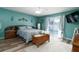 Main bedroom with teal walls, a king-size bed, and access to the pool at 2720 Queen Palm Dr, Edgewater, FL 32141