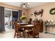 Charming dining room with a wooden table and chairs, and a view to the backyard at 2720 Queen Palm Dr, Edgewater, FL 32141