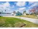 Front view of the property showcasing a paved driveway and well-maintained lawn at 2720 Queen Palm Dr, Edgewater, FL 32141