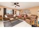 Spacious living room featuring brown leather furniture and a large TV at 2720 Queen Palm Dr, Edgewater, FL 32141