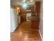 Kitchen with wood cabinets, laminate counters, and hardwood floors at 2723 Juniper Dr, Edgewater, FL 32141