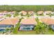 A beautiful backyard with a screened-in pool and spa with view of the tile roof at 2824 S Asciano Ct, New Smyrna Beach, FL 32168