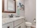 Guest bathroom with granite vanity and decorative art at 2824 S Asciano Ct, New Smyrna Beach, FL 32168